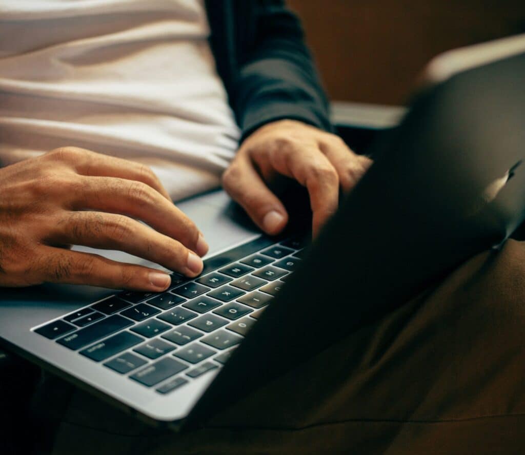 Man sitting with computer on lap