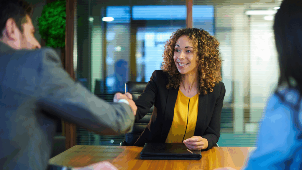 Woman sitting at desk during interview.